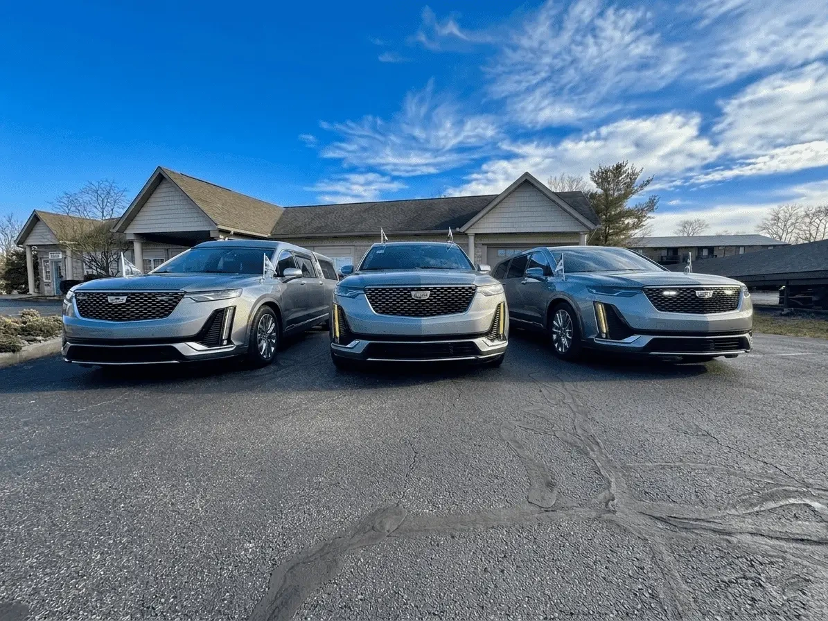 Shorac silver Cadillac vehicles lined up in front of the Shorac Family Center
