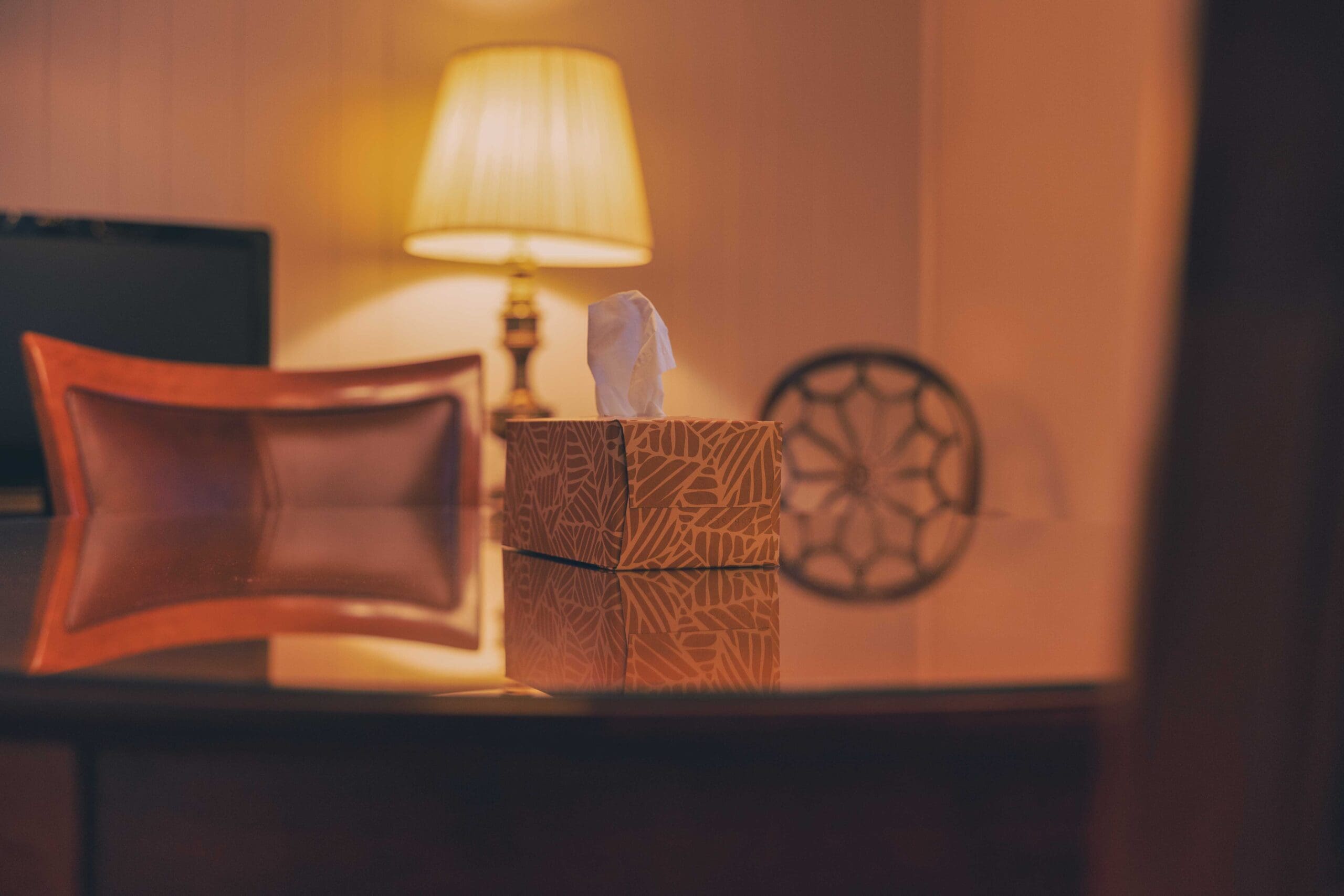 A softly lit lamp and tissues in a quiet room at Shorac Funeral Home